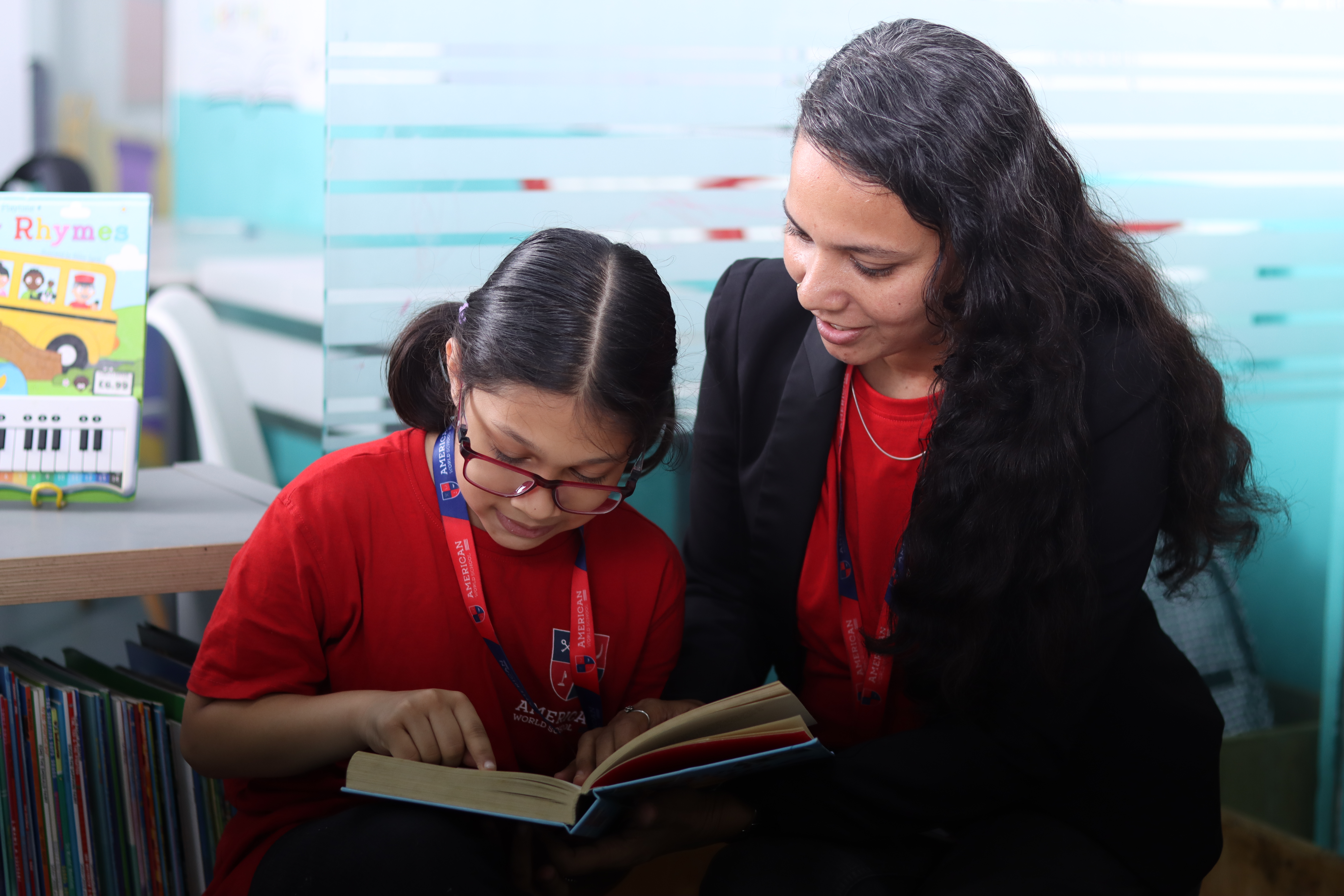 Early Years teacher reading with young AWS Falcon