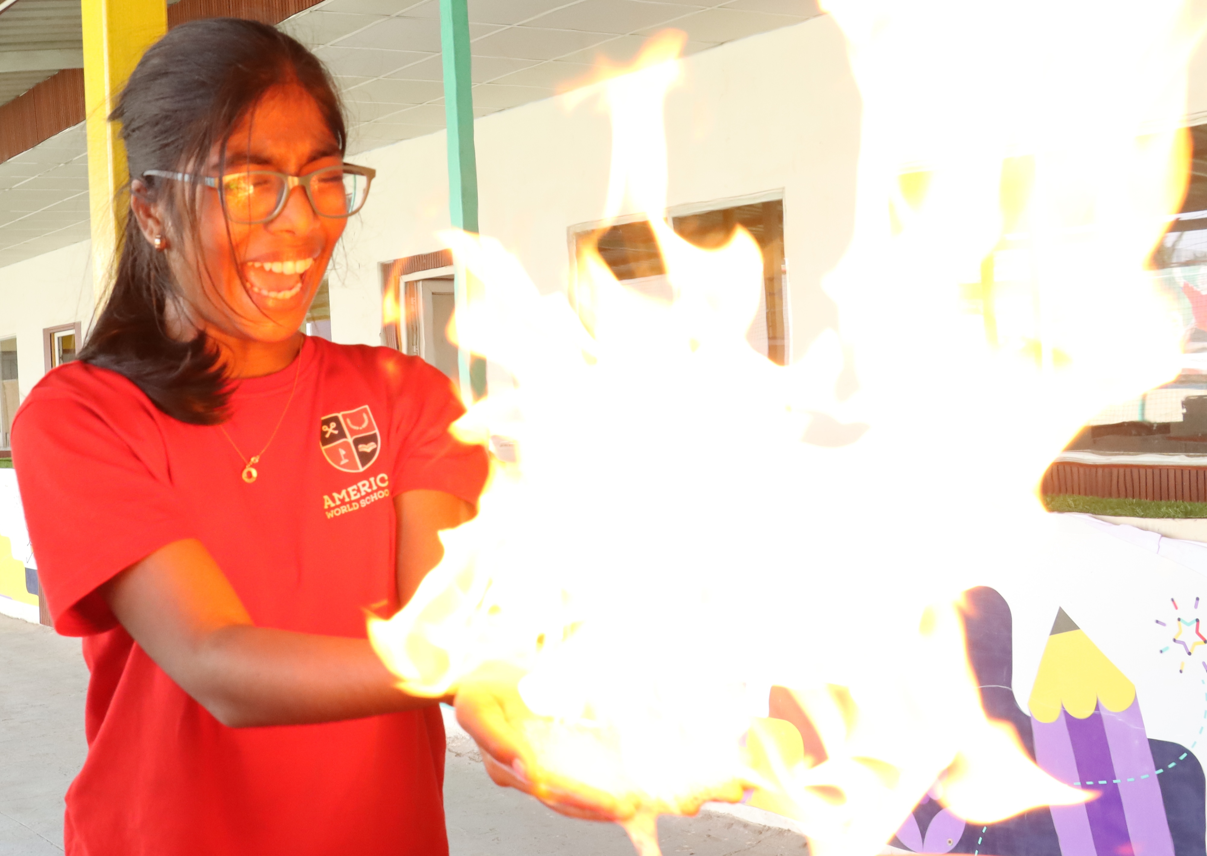 AWS high school student holding a flaming ball demonstration