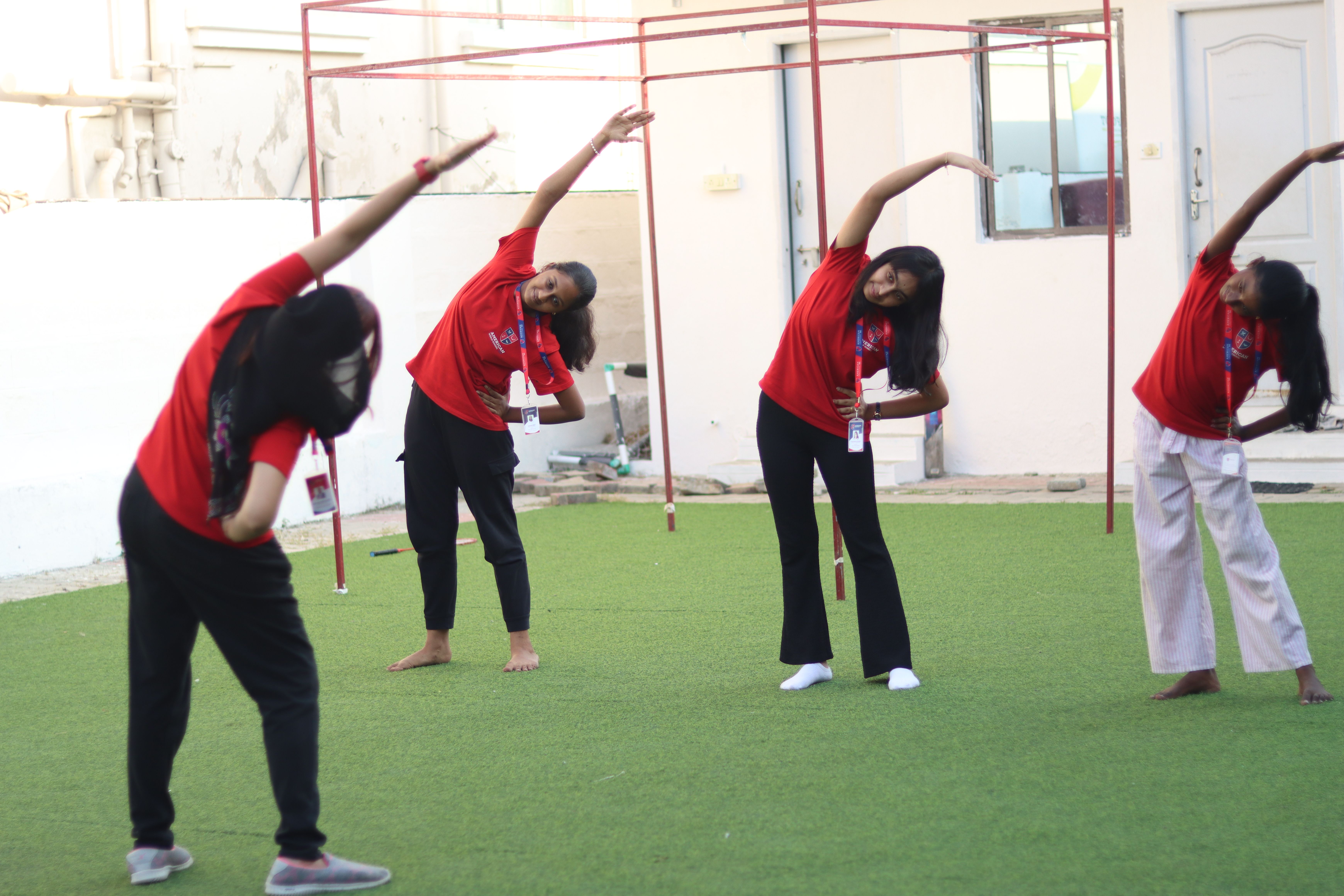 AWS middle school students stretching during yoga in the courtyard