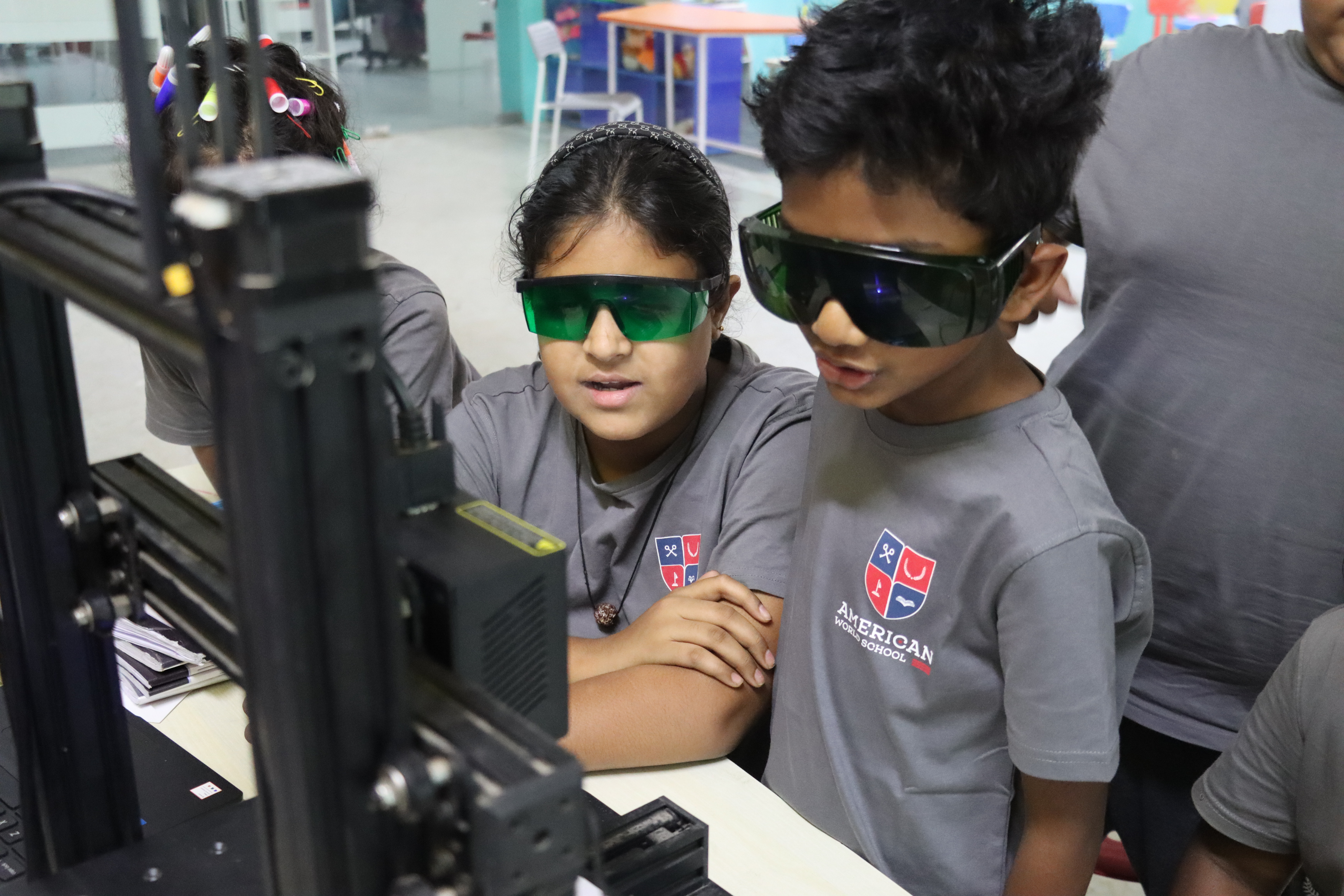 AWS students watching the 3D printer at work