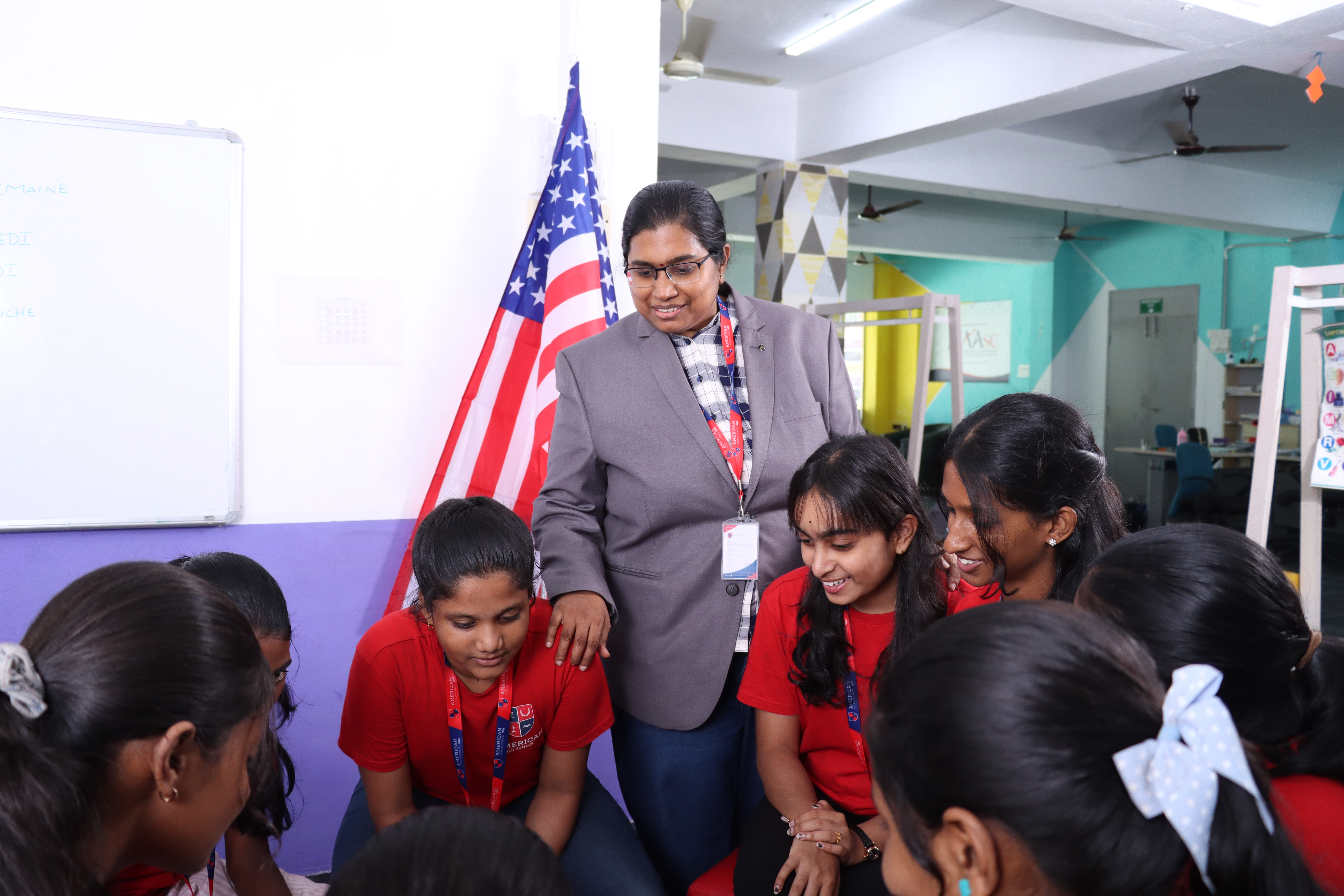 AWS teacher listening to a small group of students