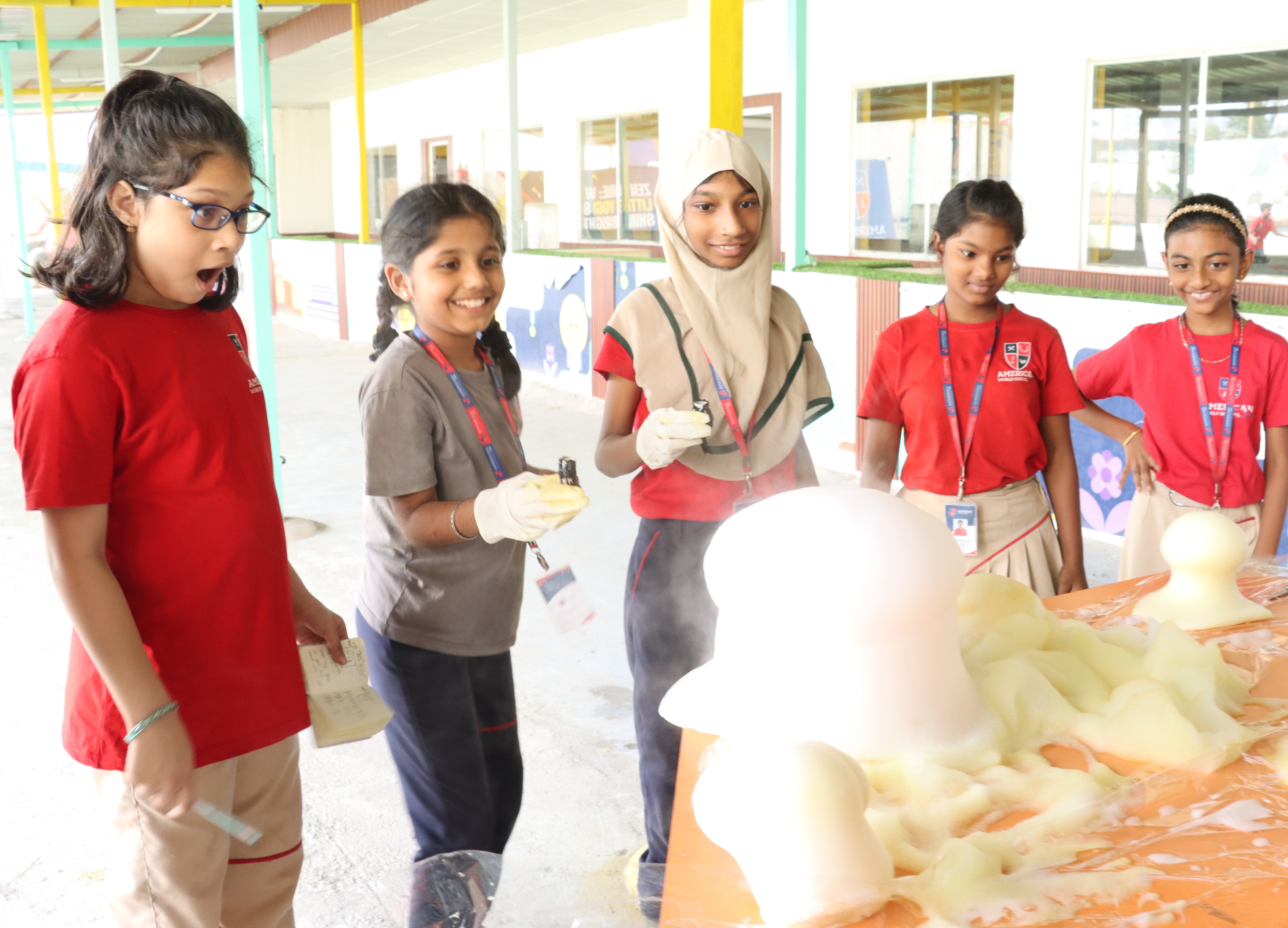 Upper Elementary students running a science experiment with safety gloves