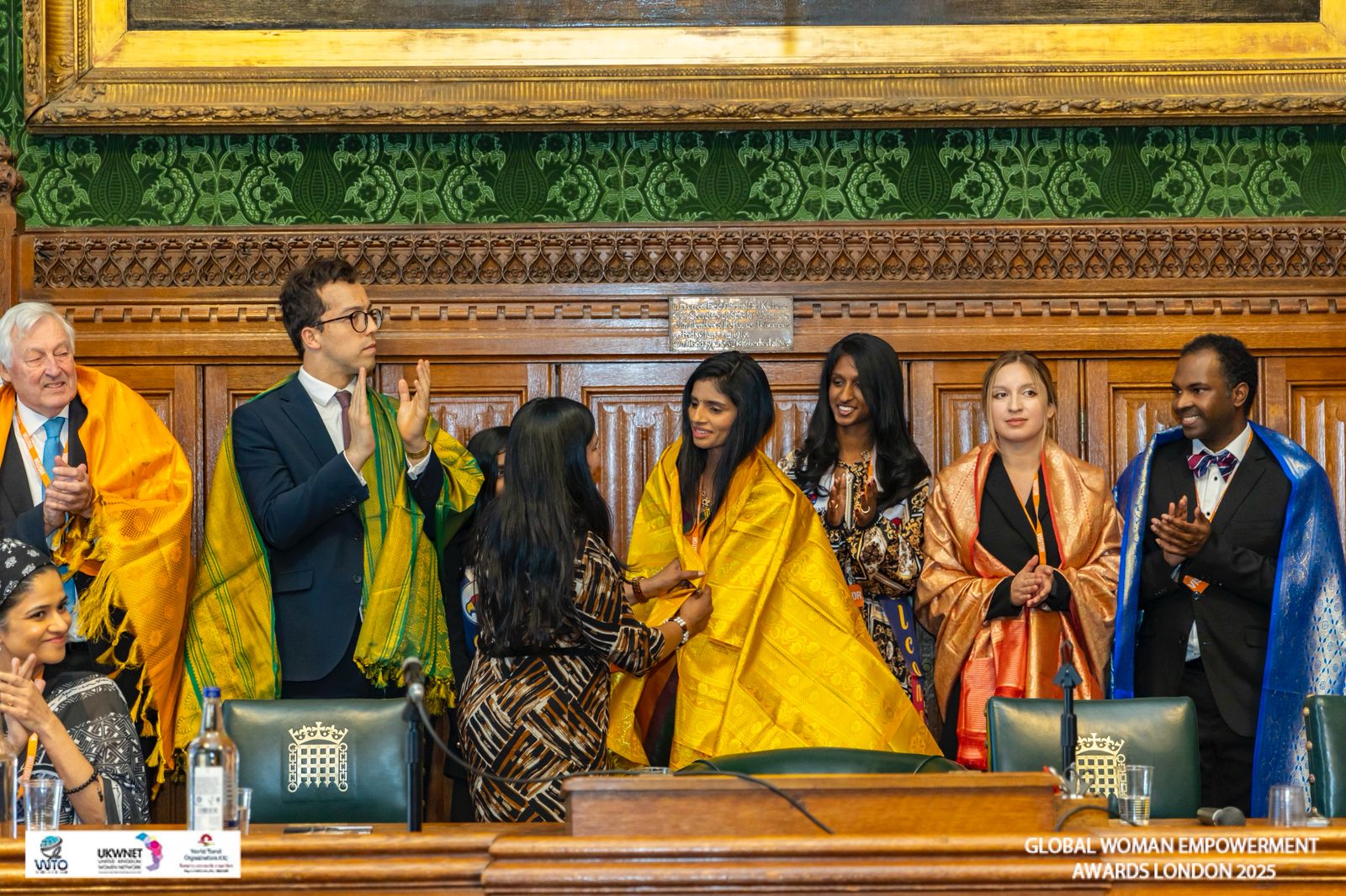 Founder Dr. Mohana Lakshmi receiving an award at the UK Parliament